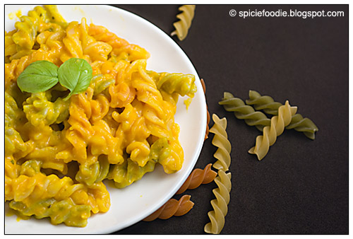 Plate; white; tricolor Fusilli; fusilli; pasta; cooked; Squash sauce; sauce; yellow; orange; green; basil; horizontal; food; organic; healthy; recipe; Italian; Fusion food; cuisine